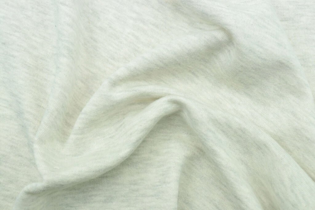 Our Values: Sustainable Baby Clothing with Heart Close-up of organic cotton knit texture — natural fibers for babies