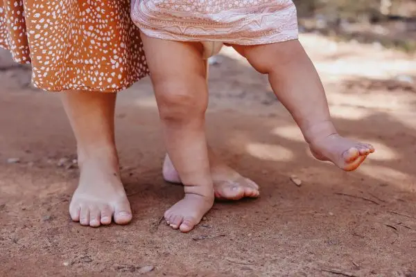 🌟 Wisdom Begins in Wonder: A Guide for Parents to Reconnect Through Their Children Bare feet of parent and baby walking side by side, symbolizing presence and mindful parenting.