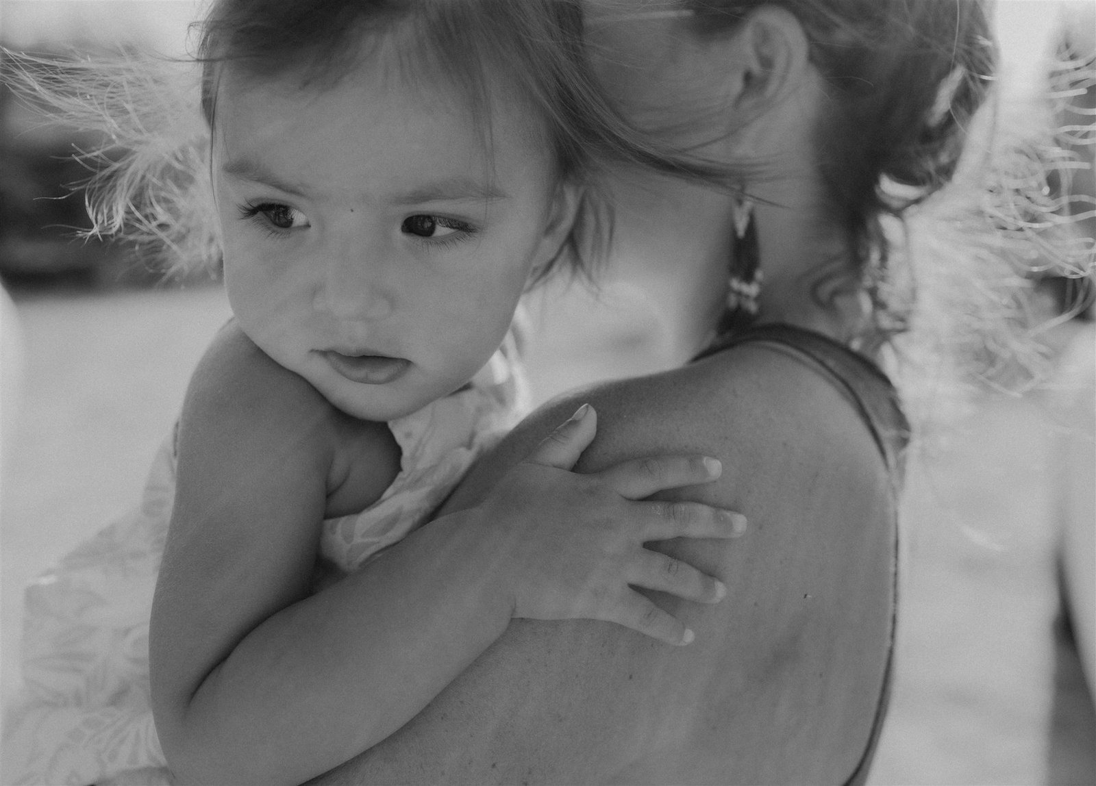 Mother holding child in arms, representing the heart behind Little Guru & Co., a sustainable babywear brand.