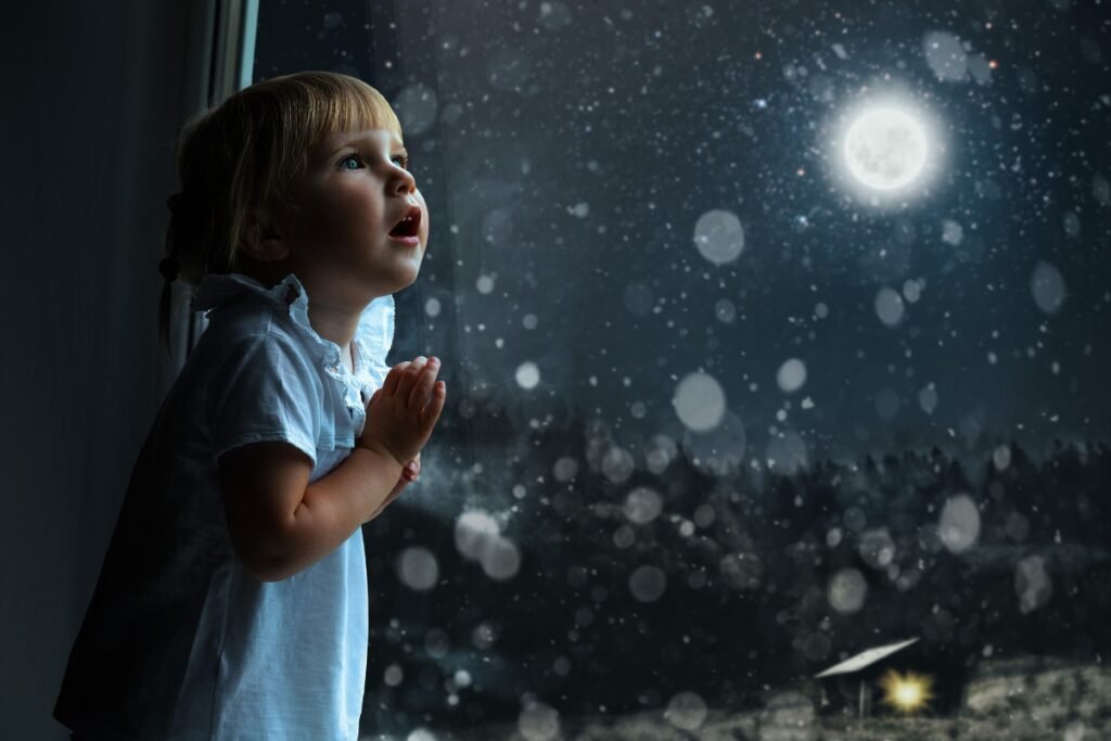 Born With a Blueprint: Your Child Arrived With Inner Wisdom Young child gazing out a window at the glowing moon and night sky, representing intuition, wonder, and a child’s inner blueprint.