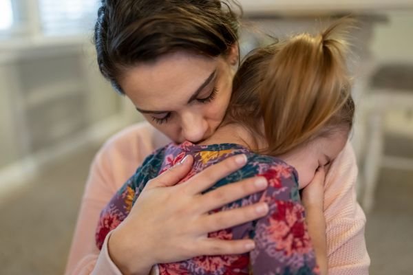 Grief in Motherhood: The Sacred Work We Rarely Name Mother embracing her child in a tender moment symbolizing the maternal mirror and sacred grief