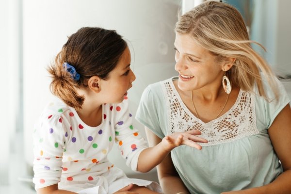Mother and daughter talking together, illustrating positive parenting language and supportive communication.
