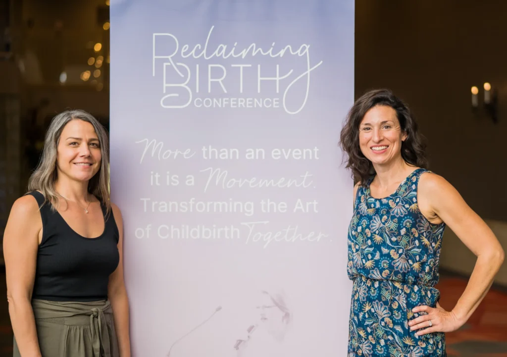 Birth Sovereignty: Why the Beginning Matters Founder, Kristen Nagel of Reclaiming Birth Gathering with banner at conference.