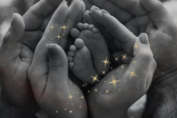Are Humans Made of Stardust? The Science & Soul Explained Newborn baby's foot held in loving hands with stars, symbolizing our cosmic origins.