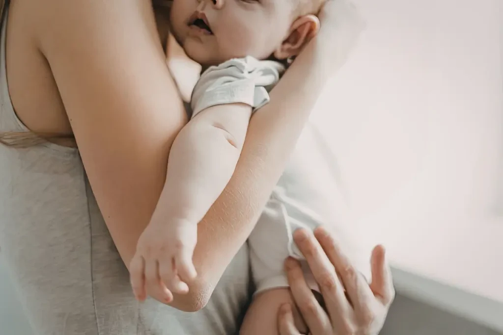 Mother holding child saying Echoes of the Stars children's affirmation cards during a mindful bedtime connection ritual.