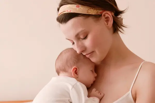 Echoes of the Stars: The Story Behind Our Children's Affirmation Cards Mother holding her newborn close, reflecting the connection behind children’s affirmation cards