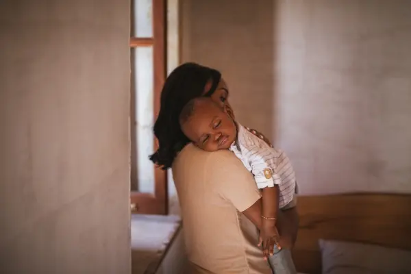 Echoes of the Stars: The Story Behind Our Children's Affirmation Cards Mother holding her sleeping child during a quiet moment of connection